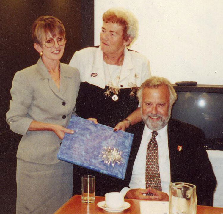 Alva Uddin , FIFe president, presents John Blythe, ACF president and his wife, Lesley Morgan-Blythe an acknowledgement for their work in getting the WCC meeting in Australia